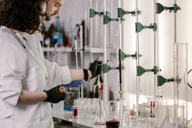 Brasil e México avançam em parceria para desenvolver vacinas de RNA mensageiro Cientistas de jaleco trabalham com tubos de ensaio em um laboratório moderno.